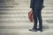 Businessman wearing black suit standing at first step of stair