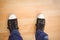 Businessman wearing canvas shoes standing on hardwood floor