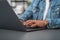 Businessman wearing casual wear is sitting typing on laptop