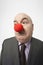 Businessman Wearing Clown Nose Frowning