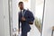 Businessman Wearing Suit Opening Door Leaving Home For Work