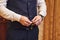 Businessman wears a jacket,male hands closeup,groom getting ready in the morning before wedding ceremony