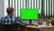 Businessman in wheelchair using computer with chroma key