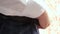 Businessman in white shirt puts belt on his pants. close-up. man gets dressed for work in the morning. office worker