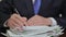 A businessman who signs documents piled up.