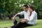 Businessman and woman use laptop in park with happy moment, sit