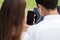 Businessman and woman use laptop and smartphone in park, sit on