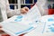 Businessman working and calculating, reads and writes reports. Office employee, table closeup. Business financial accounting