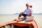 Businessman working with computer on a boat, nice outdoor office.