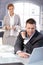 Businessman working at desk getting coffee