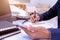 Businessman working on his desk in the office with a calculator, document, smart phone, business, finance and banking concept