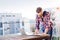 Businessman working from home on laptop, standing on balcony