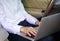 Businessman working on laptop while sitting on driver seat in  car. Lifestyle concept