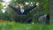 Businessman working in park taking rest and throwing hands up to sky, relaxation