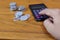 Businessman working using calculator with Money coins for Plans to Accountancy on wood table stack in office at home