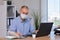 Businessman works in the office in a medical mask for coronavirus protection. New normal business practise of coronavirus covid-19