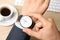 Businessman with wrist watch working at office table, closeup.