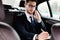 Businessman writing in notebook sitting in his car