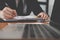 businessman writing on paper at workplace. young male entrepreneur man handwriting note at office. paperwork on table.