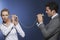 Businessman Yelling At Colleague Through Tin Can Phone