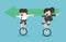 Businessmen and businesswomen  riding a bicycle holding green arrow