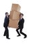 Businessmen carrying heavy boxes