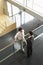 Businessmen Conversing By Railing In Office