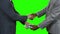 Businessmen with dollars shake hands.