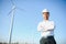 Businessmen engineering standing handsome smile front of turbine looking away