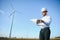 Businessmen engineering standing handsome smile front of turbine looking away