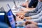 Businessmen hands typing on laptops during conference or seminar