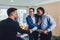 Businessmen handshaking after negotiation in office. Selective focus