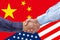 Businessmen handshaking on Usa or American and China flags merged politic and economic relationships concept