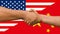 Businessmen handshaking on Usa or American and China flags merged relationship concept