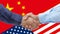 Businessmen handshaking on Usa or American and China flags merged relationship concept