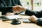 Businessmen and lawyers team up to seal a deal with a partner`s lawyer or a lawyer who discusses the contract with a hammer in the