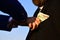 Businessmen make bargain. Male hand puts cash into suit pocket