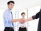 businessmen making agreement and colleague standing near b