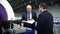 Businessmen with masks talk near table with toolbox