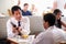 Businessmen Meeting Over Breakfast In Hotel Restaurant