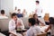 Businessmen Meeting Over Breakfast In Hotel Restaurant