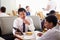 Businessmen Meeting Over Breakfast In Hotel Restaurant