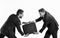 Businessmen or men in classic suits pulling black briefcase.