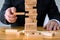 Businessmen picking dominoe blocks to fill the missing dominoes. Growing business concept