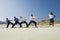 Businessmen Playing Tug Of War Against One Woman