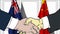 Businessmen or politicians shaking hands against flags of Australia and China. Meeting or cooperation related cartoon