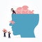 Businessmen putting a brain puzzle together in a big head.