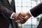 Businessmen reach out to each other to shake hands