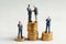 Businessmen shake hands as a symbol of a successful profitable transaction. Businessmen on a stack of gold coins as a symbol of