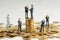 Businessmen shake hands as a symbol of a successful profitable transaction. Businessmen on a stack of gold coins as a symbol of